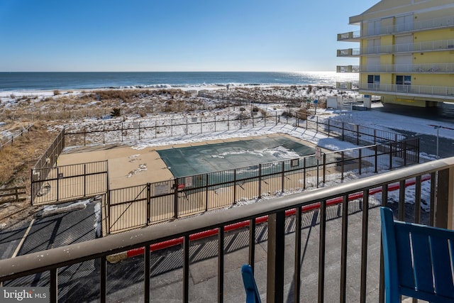 balcony featuring a beach view and a water view