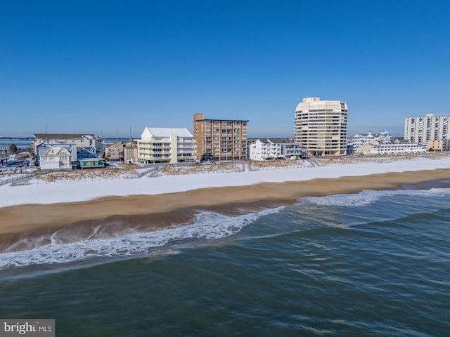 drone / aerial view with a beach view and a water view