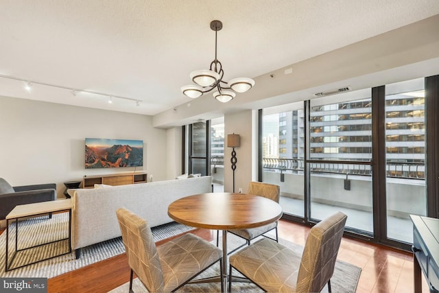 dining space featuring a chandelier and a textured ceiling