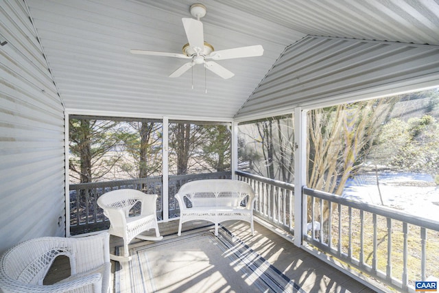 sunroom with ceiling fan and vaulted ceiling