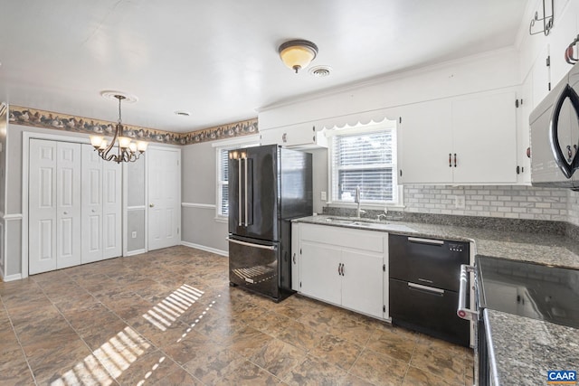 kitchen with sink, decorative light fixtures, white cabinetry, and high end black refrigerator