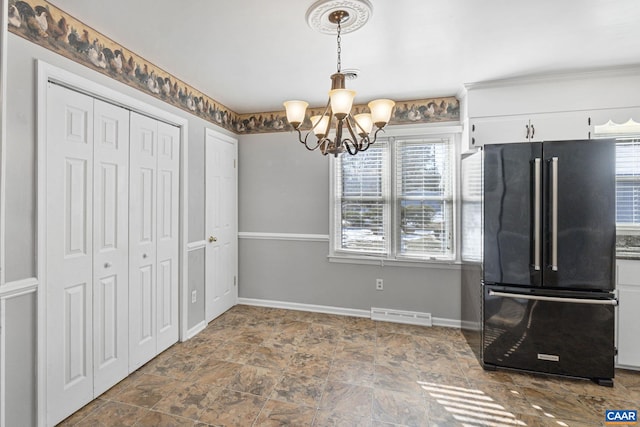 kitchen featuring high quality fridge, white cabinets, an inviting chandelier, and pendant lighting