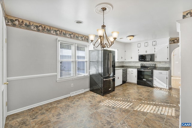 kitchen with white cabinets, pendant lighting, decorative backsplash, black appliances, and a notable chandelier