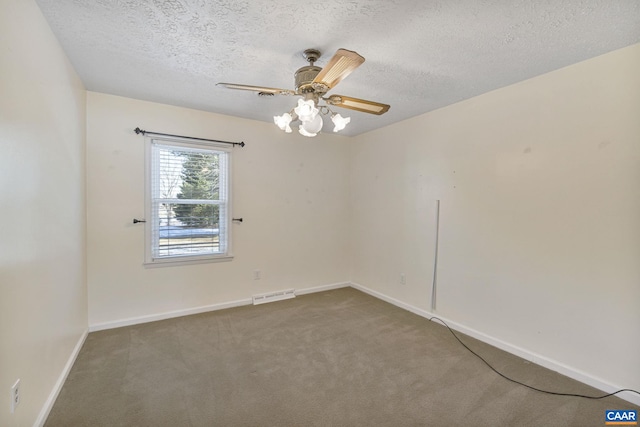 carpeted empty room featuring a textured ceiling and ceiling fan