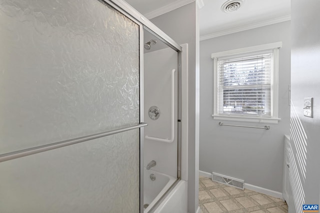 bathroom featuring bath / shower combo with glass door and crown molding