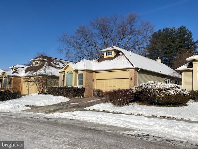 view of front facade featuring a garage and brick siding