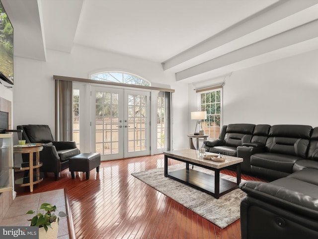 living room with plenty of natural light, wood finished floors, and french doors