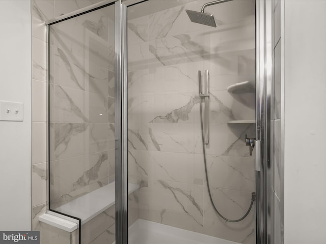 bathroom with a marble finish shower