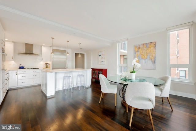 dining area featuring crown molding and dark hardwood / wood-style floors