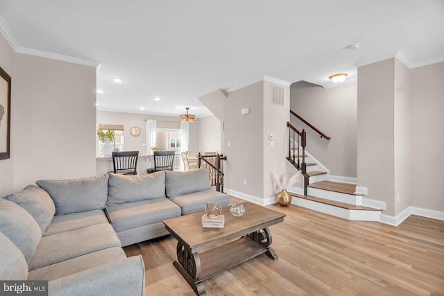 living room with light wood-type flooring and crown molding