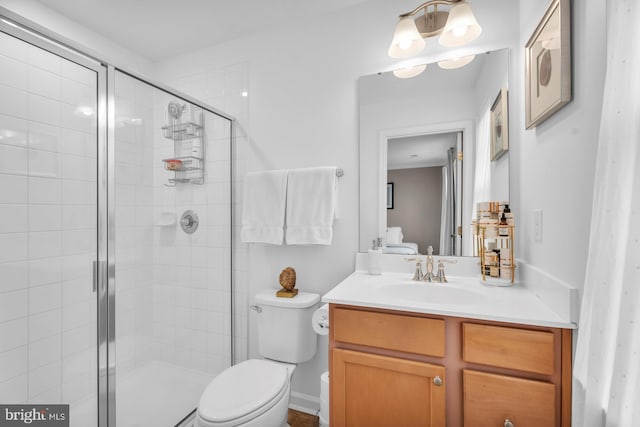 bathroom with toilet, a shower with door, and vanity