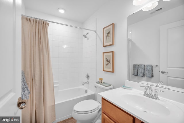 full bathroom featuring shower / bath combo with shower curtain, vanity, and toilet