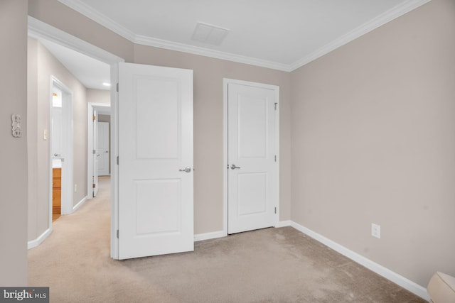 unfurnished bedroom featuring crown molding and light colored carpet