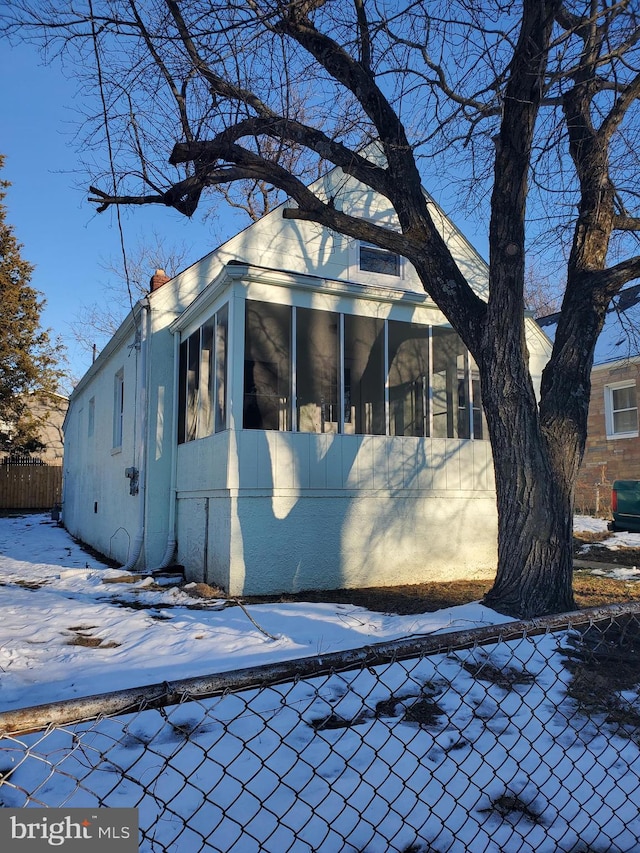 view of front facade with a sunroom