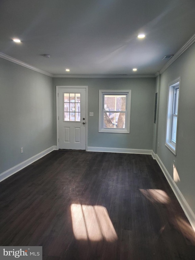 interior space with dark hardwood / wood-style flooring and crown molding