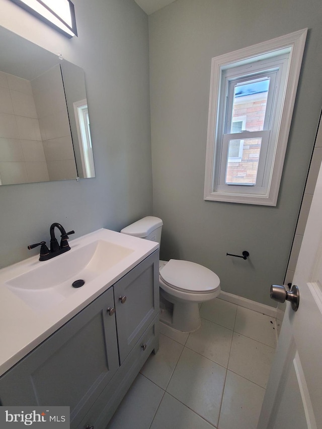 bathroom featuring tile patterned floors, vanity, and toilet