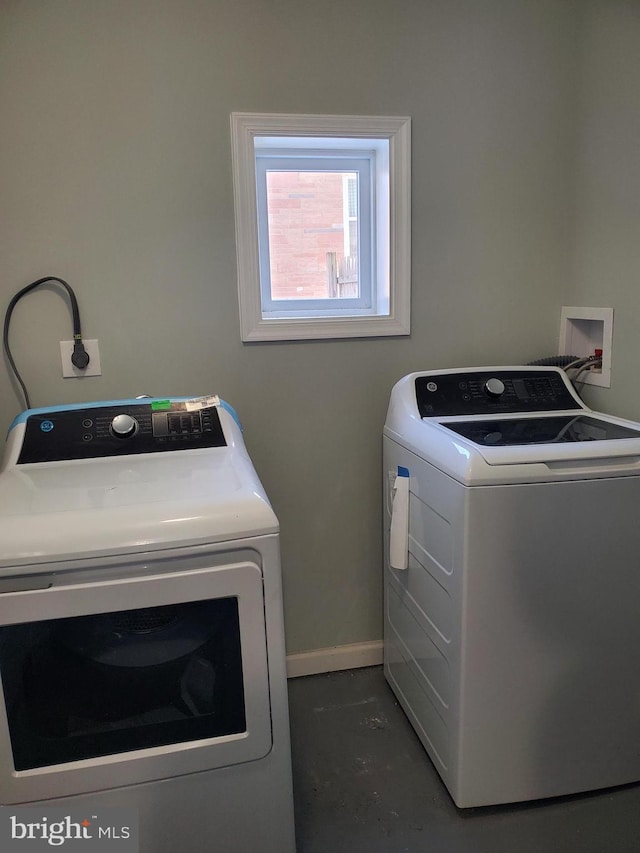 clothes washing area with washer and clothes dryer