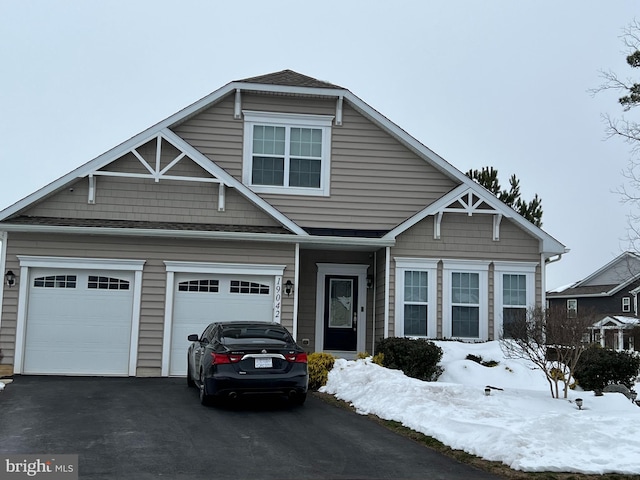 view of front of house featuring aphalt driveway and a garage