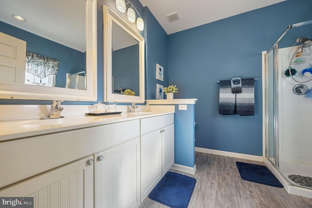 bathroom featuring vanity, an enclosed shower, and hardwood / wood-style floors