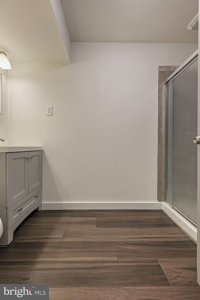 bathroom with vanity, hardwood / wood-style floors, and an enclosed shower