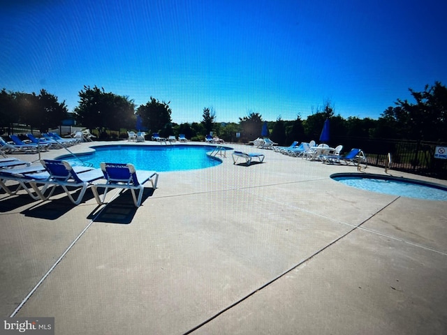 view of swimming pool featuring a patio area