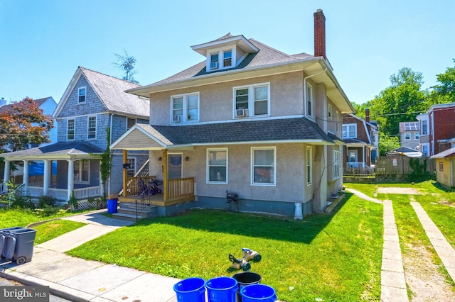 view of front of property with a porch and a front yard