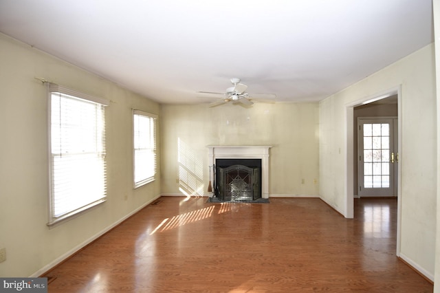 unfurnished living room with ceiling fan and dark hardwood / wood-style floors