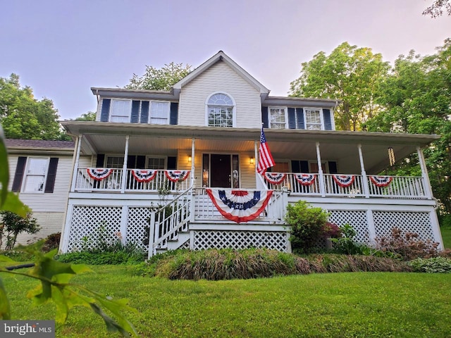 view of front of home with a porch and a lawn