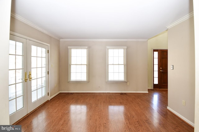 spare room with french doors, wood-type flooring, and crown molding