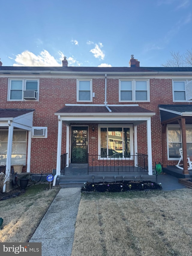 multi unit property with a front lawn and a porch