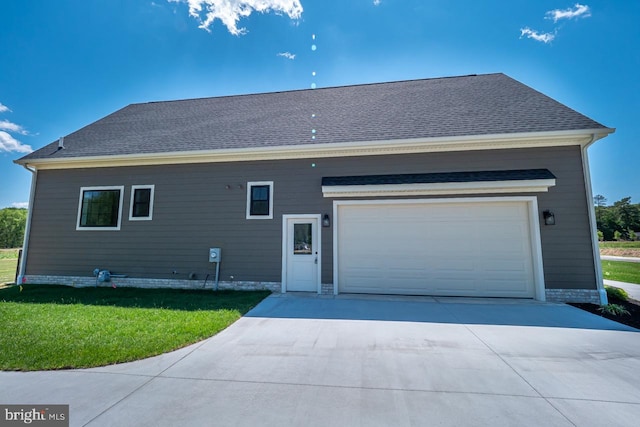 exterior space featuring driveway, a shingled roof, a garage, and a front lawn