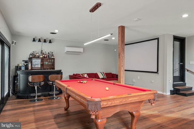 recreation room featuring bar, billiards, a wall mounted AC, and hardwood / wood-style floors