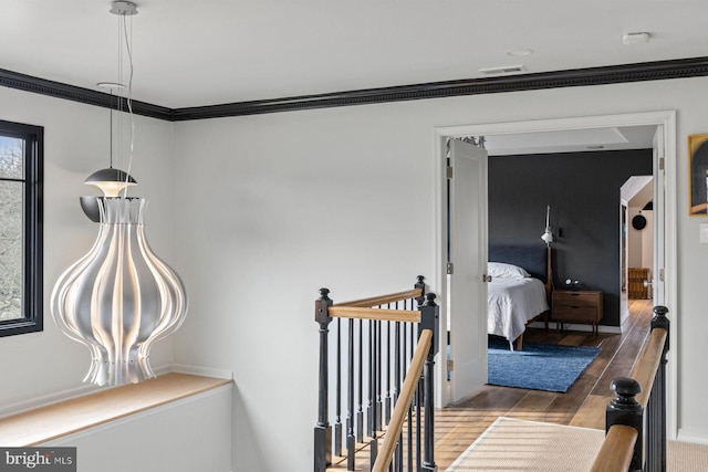 hallway featuring crown molding and hardwood / wood-style floors