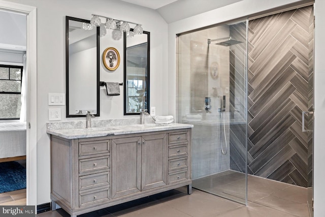 bathroom featuring vanity and tiled shower