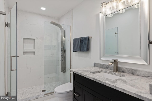 bathroom with vanity, toilet, and walk in shower