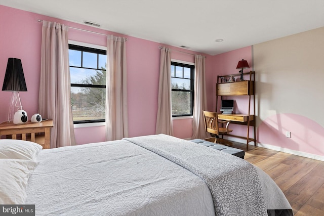 bedroom with wood-type flooring