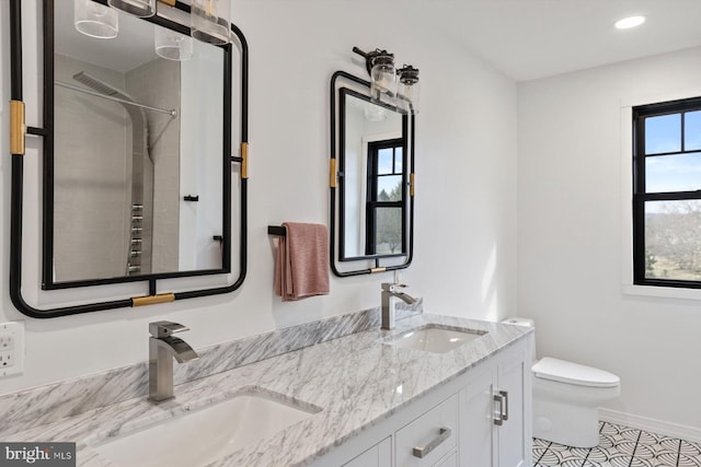 bathroom with toilet, tile patterned floors, and vanity