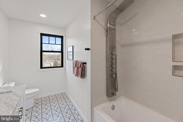 full bathroom with vanity, toilet, tiled shower / bath, and tile patterned flooring