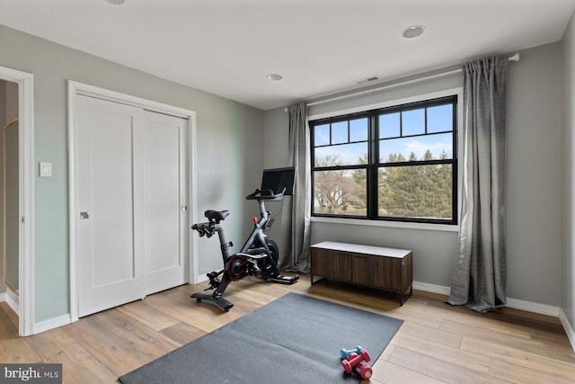 workout area with light wood-type flooring