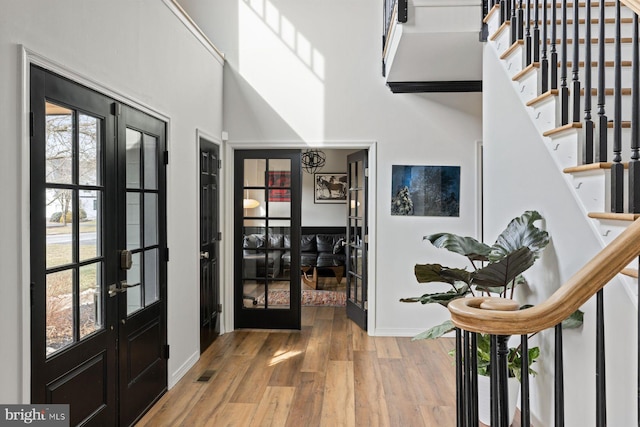 entryway with hardwood / wood-style flooring and french doors