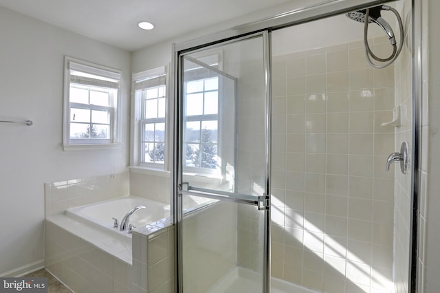 bathroom featuring tile patterned floors and separate shower and tub