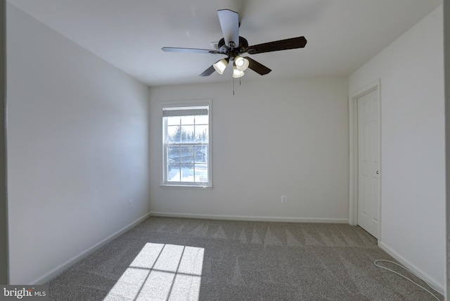 carpeted spare room with ceiling fan