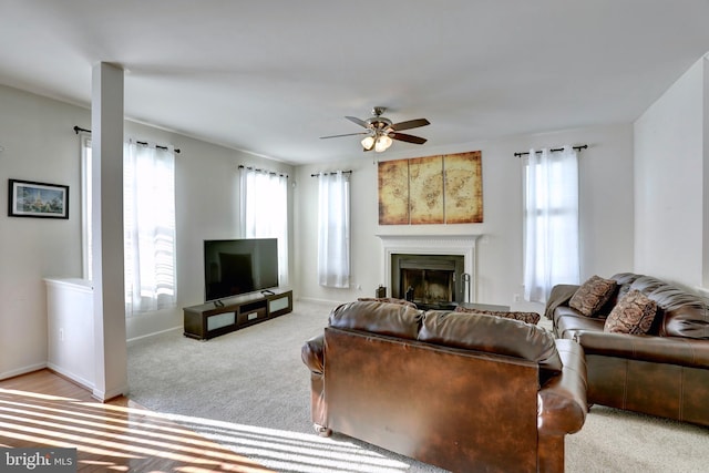 carpeted living room with ceiling fan