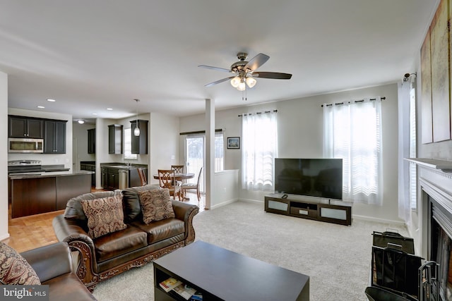 living room with ceiling fan and light carpet