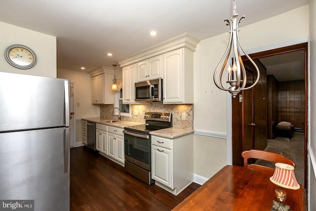 kitchen featuring sink, decorative backsplash, hanging light fixtures, light stone counters, and stainless steel appliances