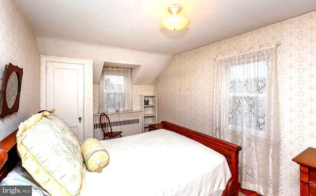 bedroom featuring vaulted ceiling and radiator heating unit