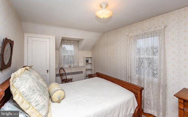 bedroom featuring vaulted ceiling and radiator heating unit