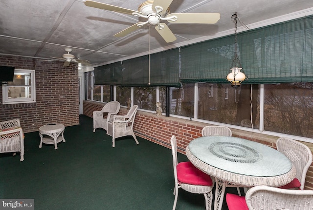 sunroom featuring ceiling fan