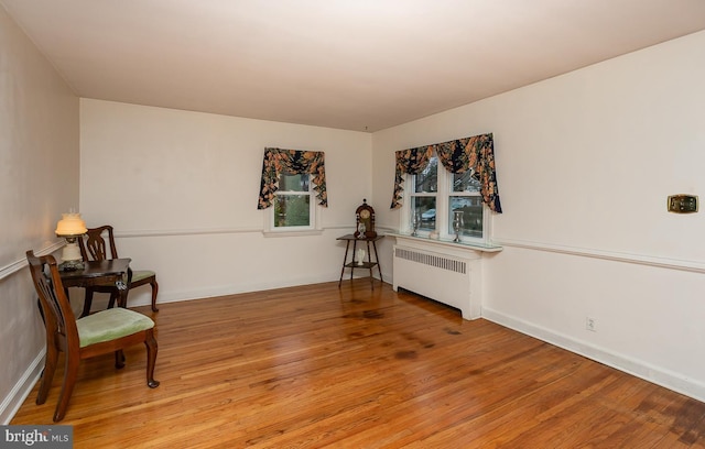 living area featuring radiator and light hardwood / wood-style flooring