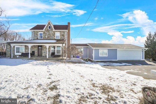 view of front of property with covered porch and a garage